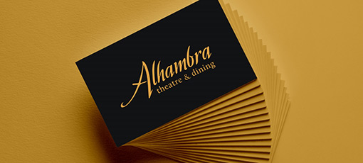 A stack of gold and black Alhambra Theatre gift cards